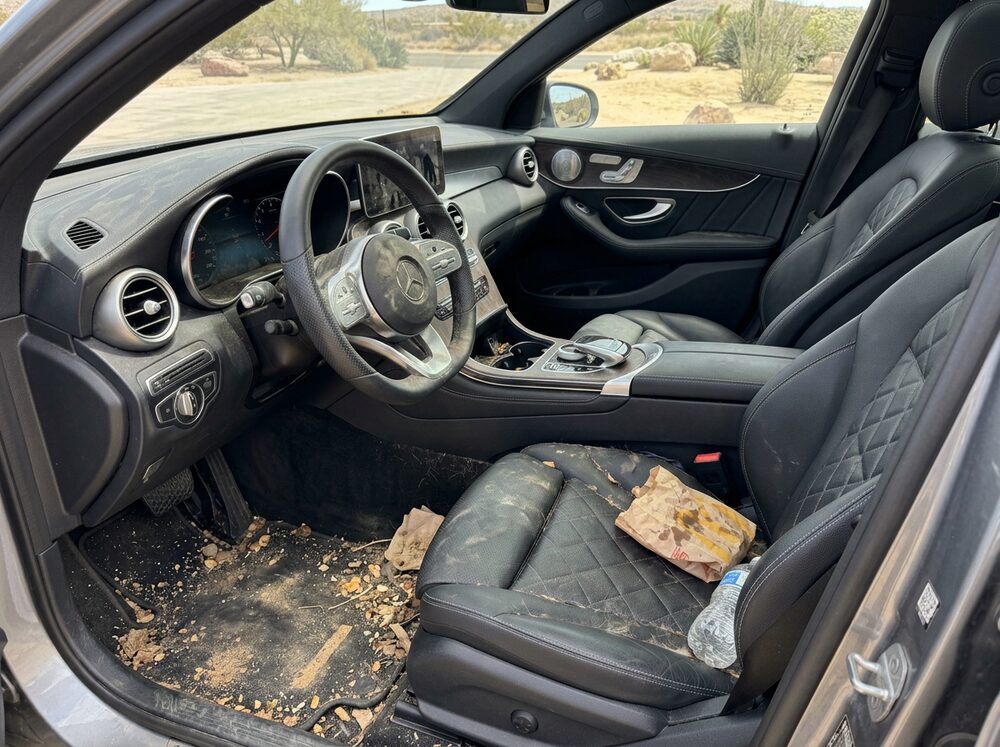 Dirty Mercedes-Benz interior with sand, crumbs and trash before detailing